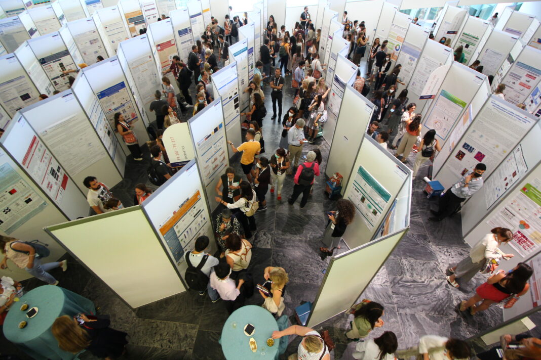presenting research poster at conference